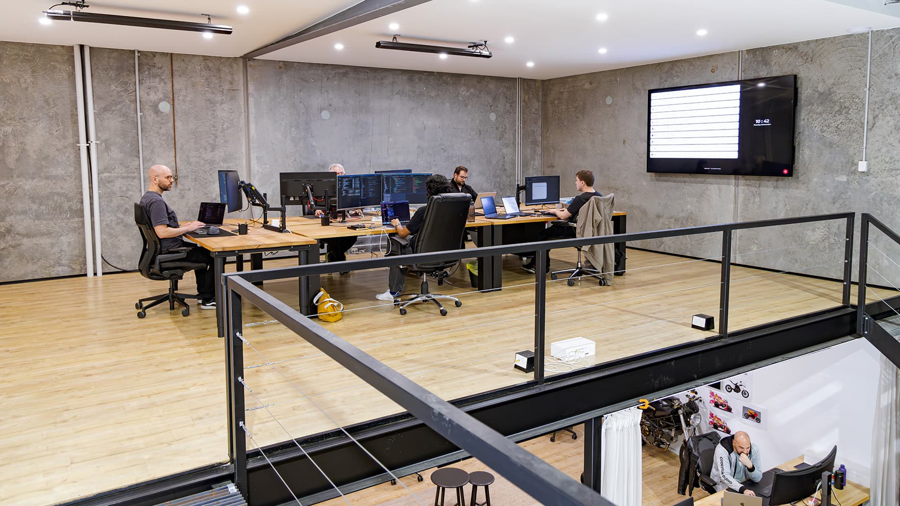 The CodeFish Studio mezzanine looking down over the main workspace and desks