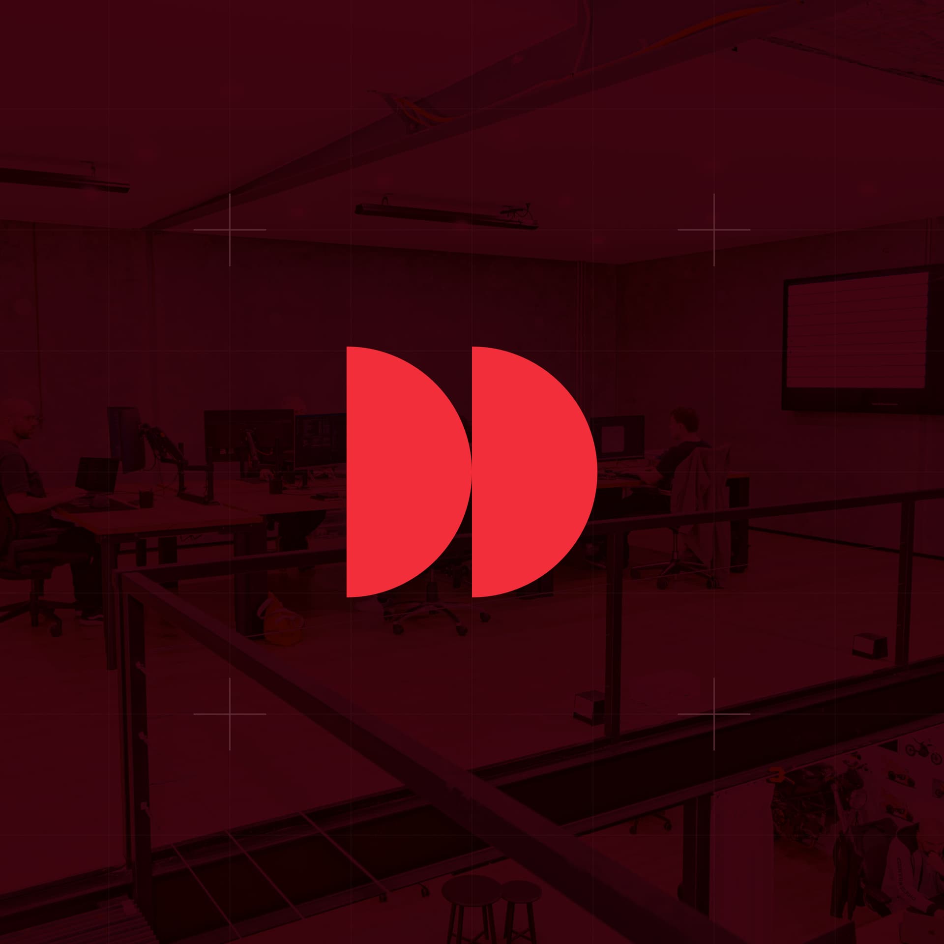 CodeFish Studio twin half-disc glyph over a red-tinted photo of the studio work floor